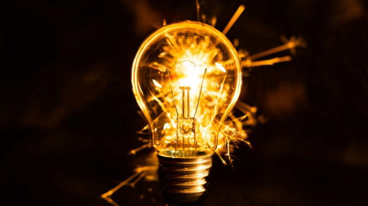 a light bulb with a flame